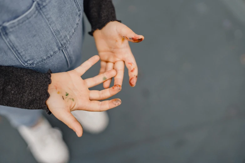 a close up of a person with dirty hands, an album cover, by Julia Pishtar, trending on pexels, antipodeans, childhood friend vibes, leafs, bruises, holding hot sauce