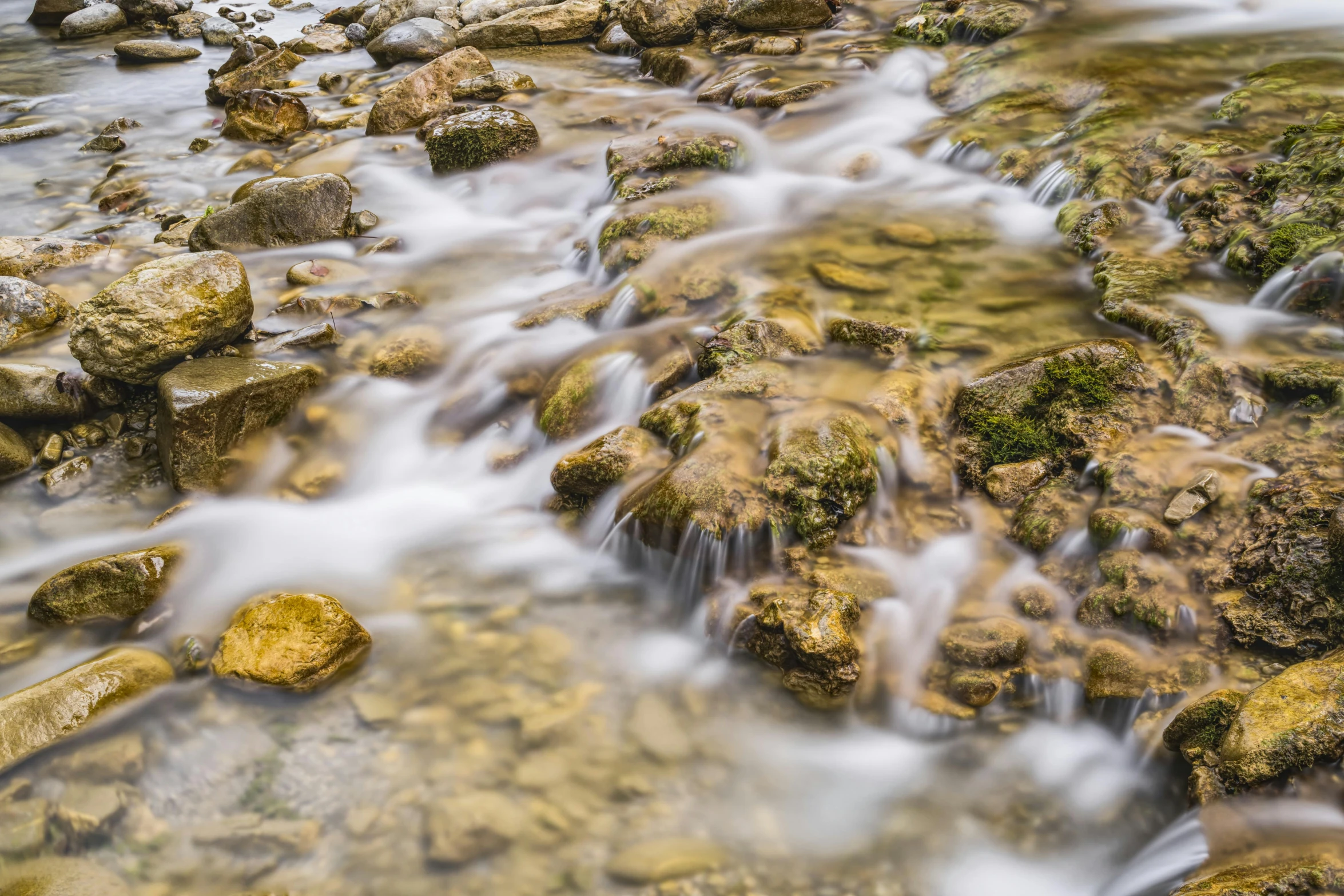 a stream running through a lush green forest, by Mirko Rački, pexels contest winner, floating rocks, marble!! (eos 5ds r, water texture, brown