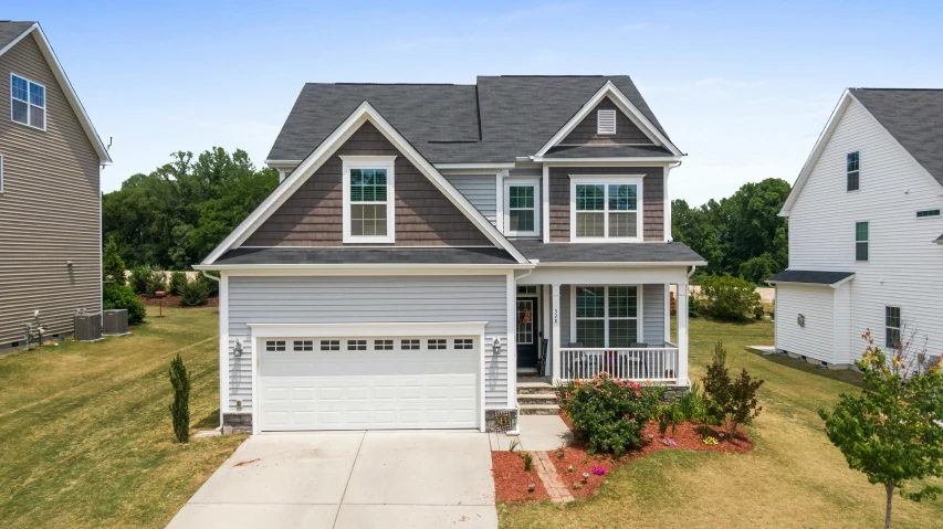 a two story house sitting on top of a lush green field, profile image, white plank siding, drone photograpghy, avatar image