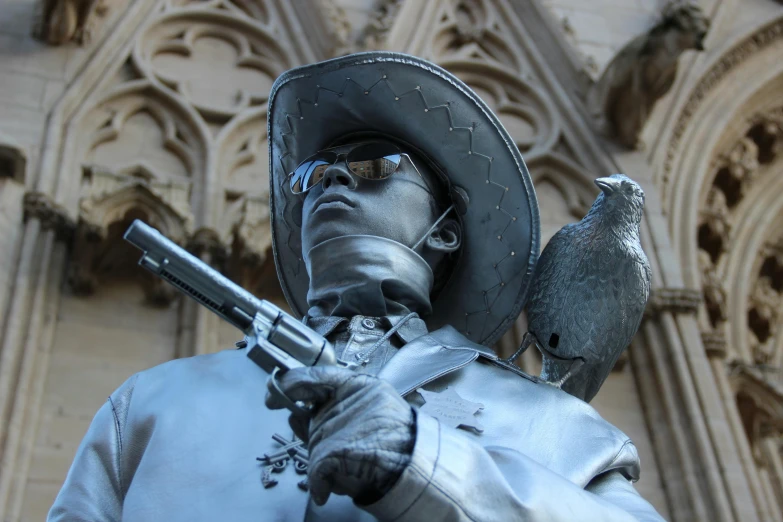 a statue of a man holding a gun and a bird, a statue, inspired by Prince Hoare, dressed as a western sheriff, close up guns and roses, lady of elche, daniel oxford