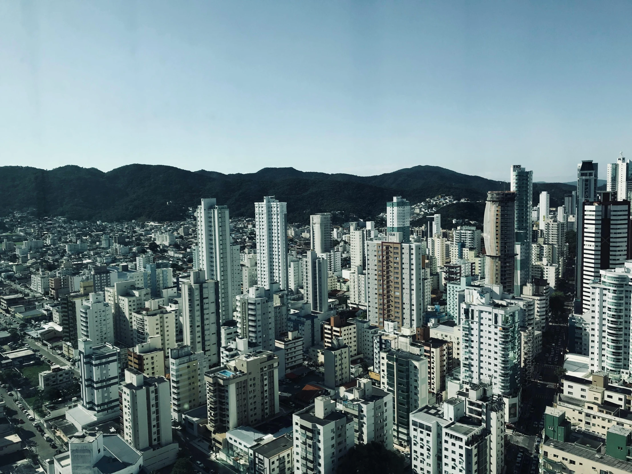 a view of a city from a tall building, by Fernando Gerassi, pexels contest winner, brutalism, henrique alvim corrêa, 2000s photo, paradise in the background, music video