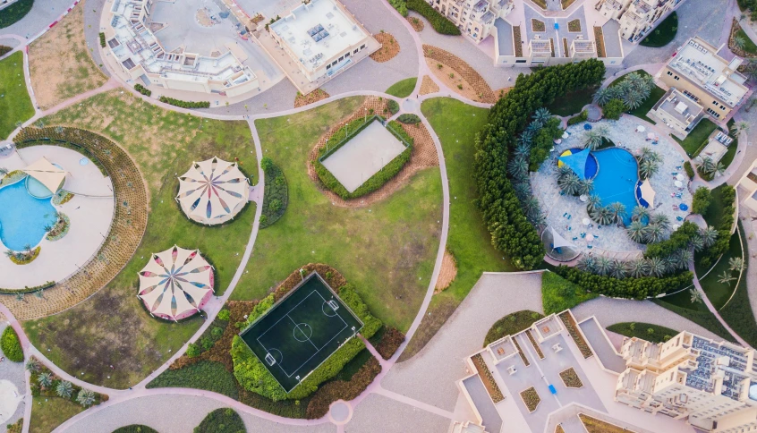 a bird's eye view of an aerial view of a resort, by Ahmed Yacoubi, pexels contest winner, conceptual art, school courtyard, city park, multiple wide angles, round buildings in background