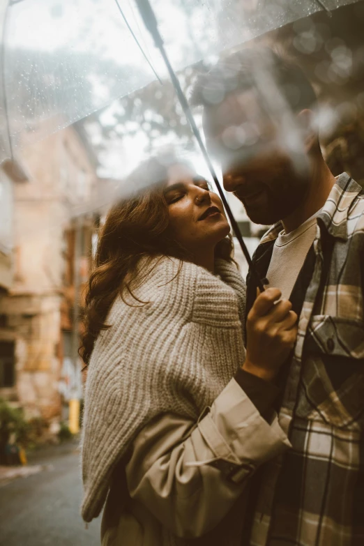 a man and woman standing under an umbrella, pexels contest winner, romanticism, black haired girl wearing hoodie, intimately holding close, gif, vintage vibe