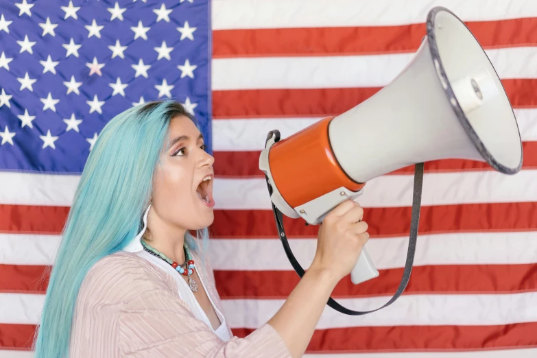 a woman with blue hair holding a megaphone in front of an american flag, pokimane, background image, politicians, craigslist photo