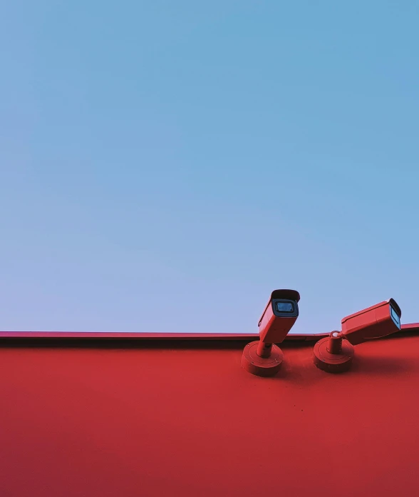 two cameras sitting on top of a red roof, by Carey Morris, unsplash, conceptual art, brand colours are red and blue, security, ilustration, caught on security camera