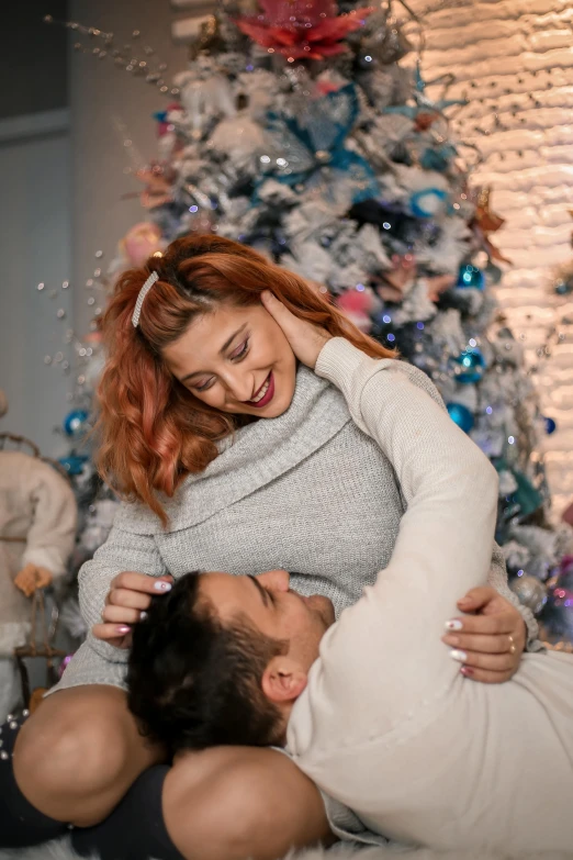 a man and woman laying on the floor in front of a christmas tree, pexels contest winner, renaissance, hugging her knees, redhead woman, 15081959 21121991 01012000 4k, an enormous silver tree