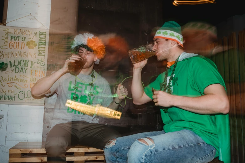 a couple of men sitting on top of a wooden bench, beer glasses, irish, underground party, profile image