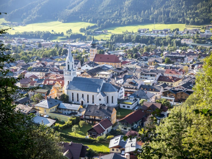a view of a town from the top of a hill, by Tobias Stimmer, pexels contest winner, square, sunny summer day, alpine, church in the background