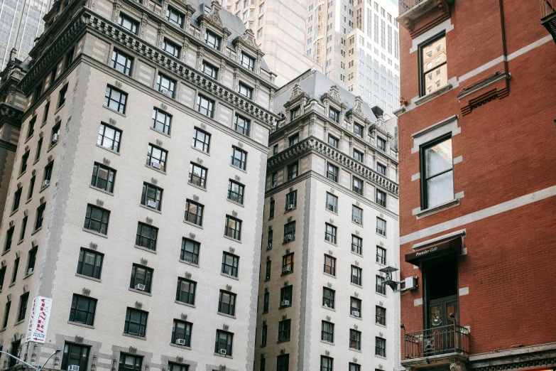 a red double decker bus driving down a city street, a photo, pexels contest winner, neoclassicism, cramped new york apartment, building facing, new york buildings, ignant