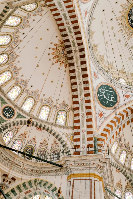 a clock mounted to the ceiling of a building, inspired by Osman Hamdi Bey, trending on pexels, arabesque, mosque interior, 2 5 6 x 2 5 6 pixels, interior of a marble dome, green