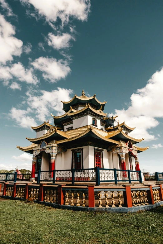 a building sitting on top of a lush green field, inspired by An Zhengwen, trending on unsplash, cloisonnism, colourful biomorphic temple, blue and white and gold, 2 5 6 x 2 5 6 pixels, exterior