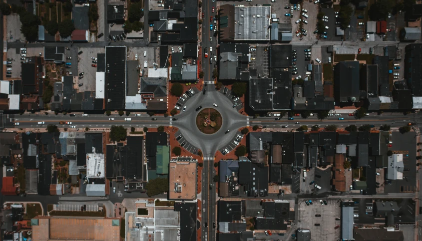 an aerial view of a city with lots of buildings, an album cover, by Carey Morris, pexels contest winner, intersection, from wheaton illinois, round format, square