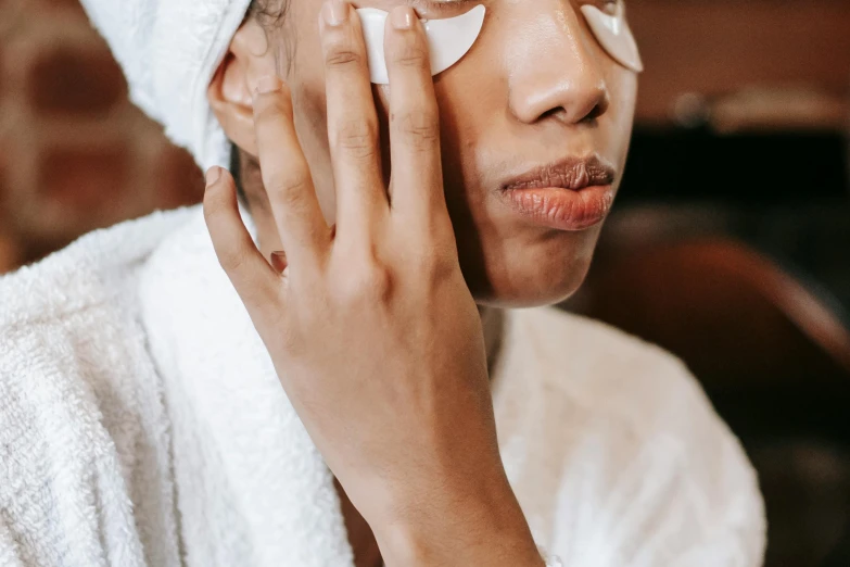 a close up of a person with a towel on their head, trending on pexels, bags under eyes, wearing white silk robe, thumbnail, candy treatments