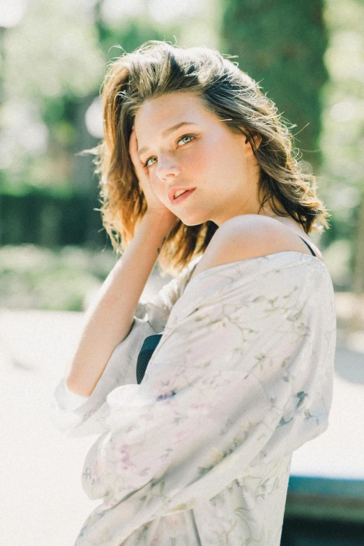 a woman posing for a picture in a park, a portrait, by Adam Marczyński, unsplash, miranda kerr, wearing a simple robe, young teen, hollywood promotional image