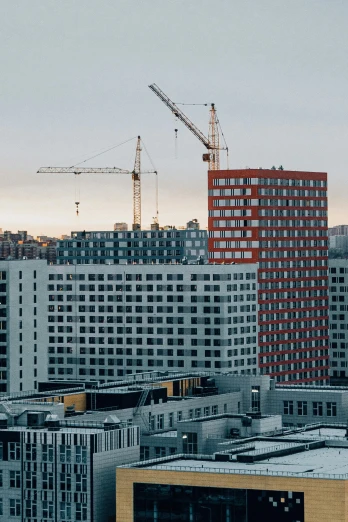 a city filled with lots of tall buildings, pexels contest winner, constructivism, finland, construction site, low quality photo, promo image