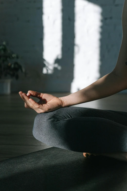 a woman sitting in the middle of a yoga pose, pexels contest winner, light and space, hands not visible, low quality photo, promo image, relaxed posture