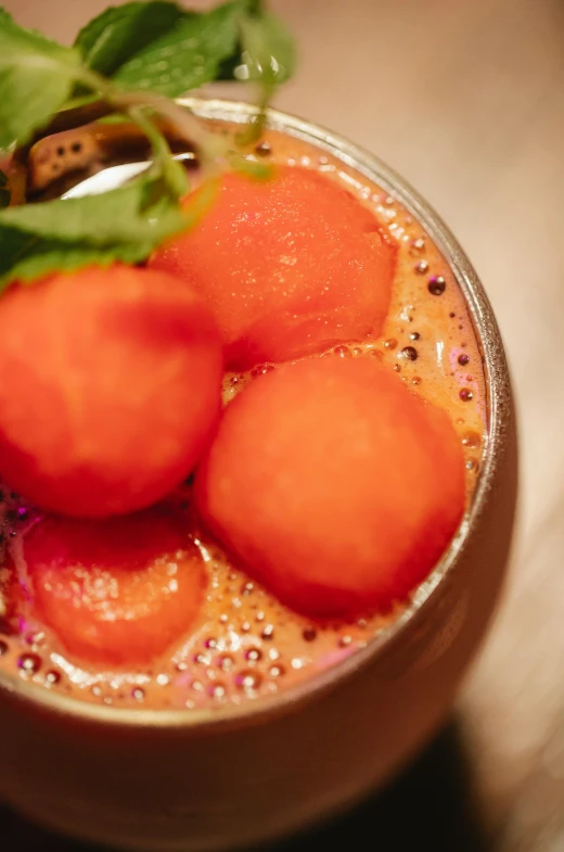 a close up of a bowl of food on a table, slush, bulbous, neon orange, lush