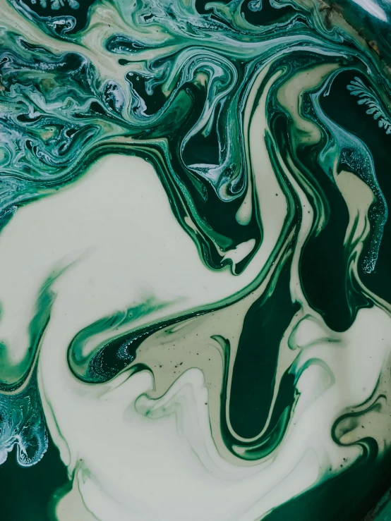 a bowl filled with liquid sitting on top of a table, an abstract painting, inspired by Art Green, trending on unsplash, green snakes, closeup 4k, made of water, creamy