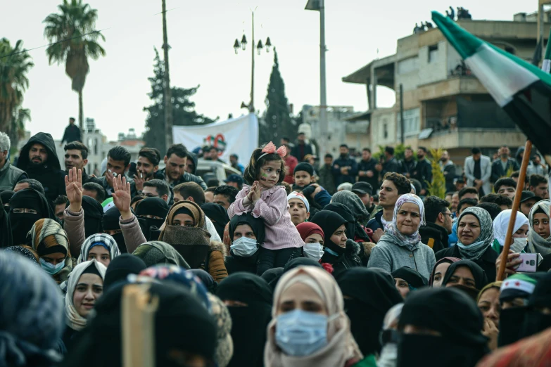 a group of people that are standing in the street, by Matija Jama, hurufiyya, protest, slide show, gettyimages, balaclava