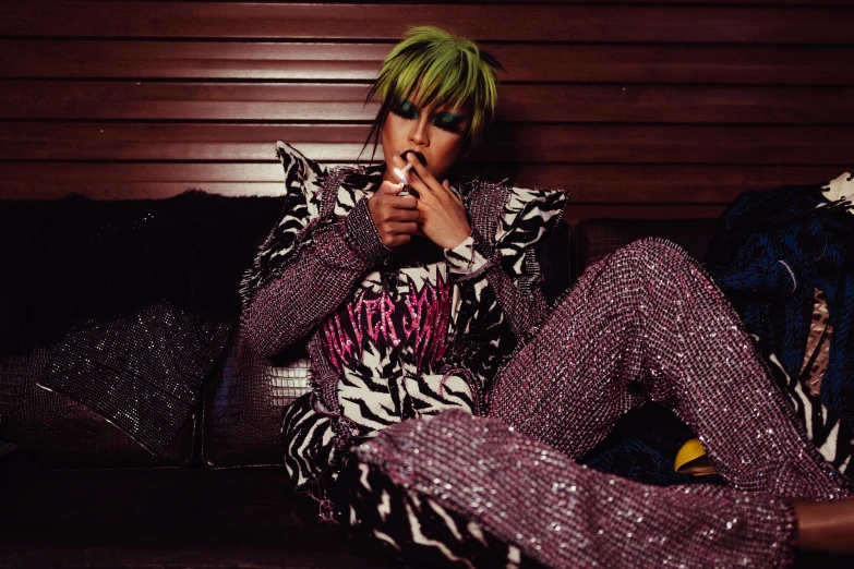 a woman sitting on a couch smoking a cigarette, an album cover, trending on pexels, bright green hair, bright trouser suit for a rave, outlive streetwear collection, official vuitton editorial