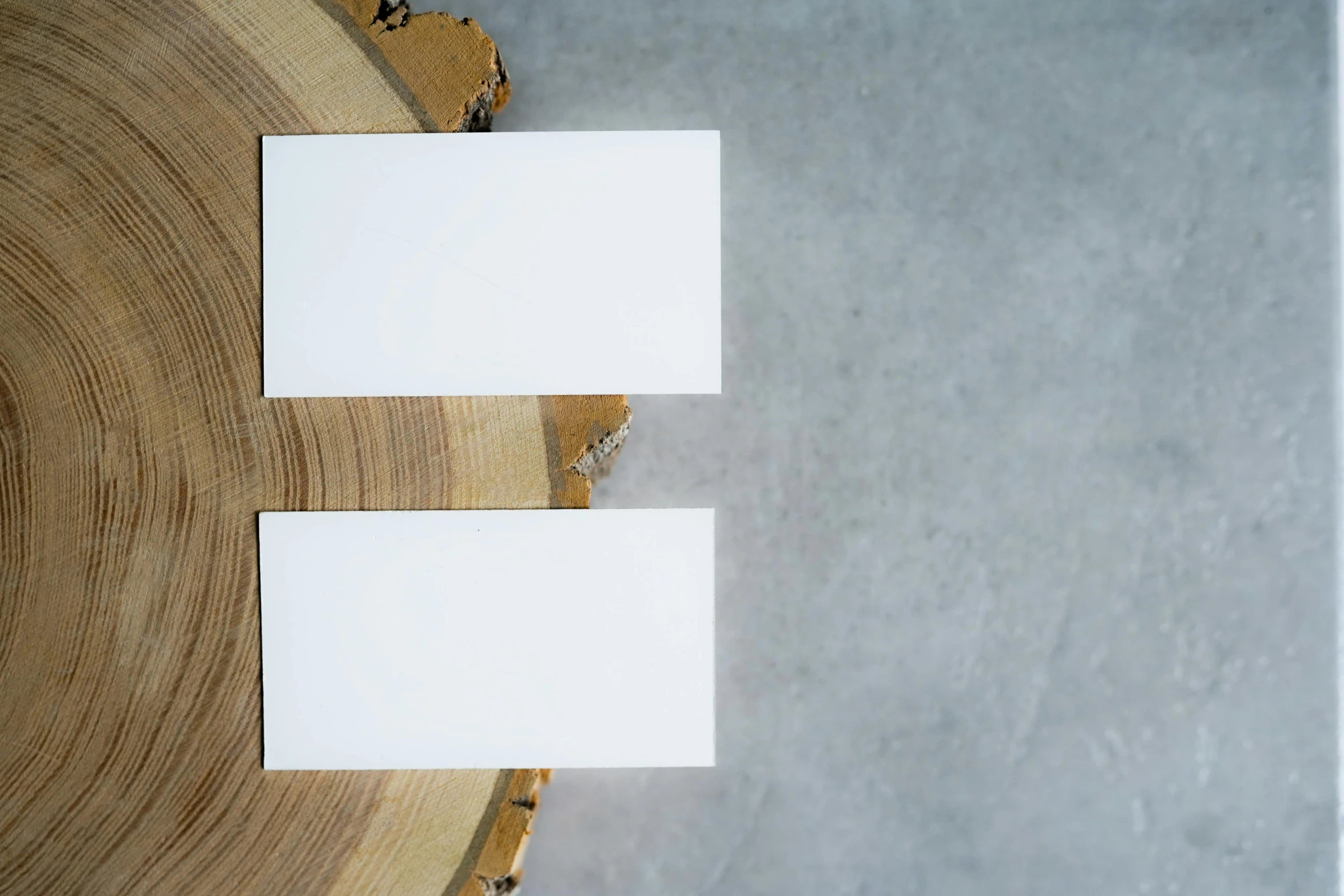 two business cards sitting on top of a piece of wood, by Jan Rustem, unsplash, private press, made of all white ceramic tiles, blank background, portrait image, white: 0.5