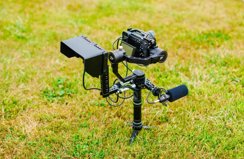 a camera sitting on top of a tripod in a field, with robotic arms, sony a7z, portrait, panavision panaflex x
