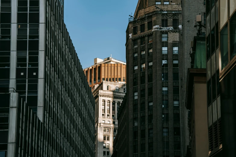 a city street with tall buildings and a clock tower, pexels contest winner, modernism, new york buildings, afternoon light, view from bottom to top, architecture photo