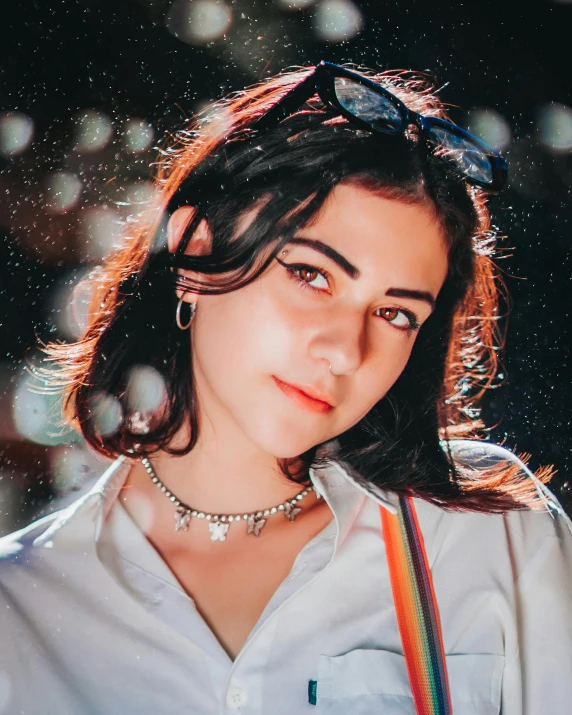 a woman wearing a white shirt and suspenders, a colorized photo, inspired by Ion Andreescu, trending on pexels, young middle eastern woman, a glowing halo, charli bowater, grainy picture