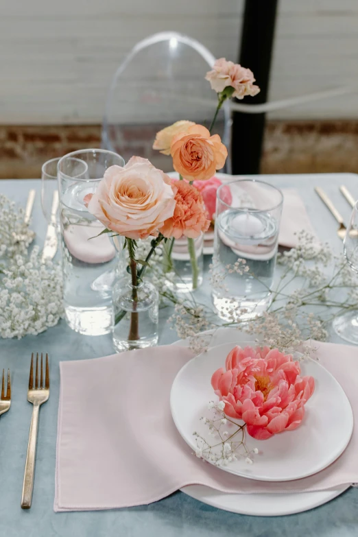 a white plate topped with pink flowers on top of a table, glassware, detail shot, linen, full-body