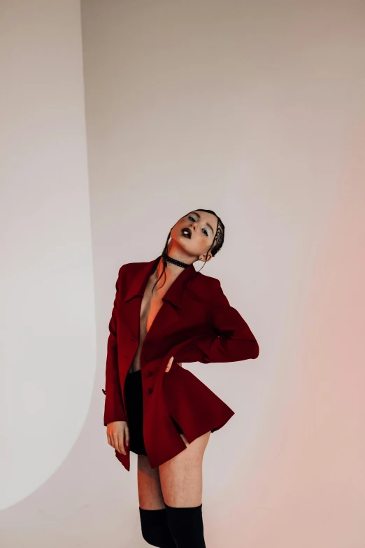 a woman in a red suit posing for a picture, an album cover, inspired by Elsa Bleda, trending on pexels, sasha grey, fashion studio lighting, gif, heartbreak