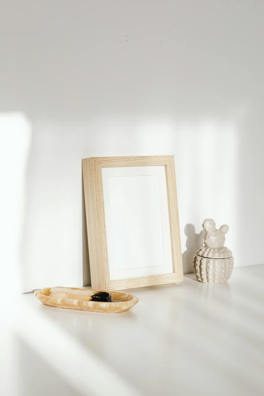 a picture frame sitting on top of a white table, pexels contest winner, natural soft rim light, blonde cream, collection product, mid shot photo