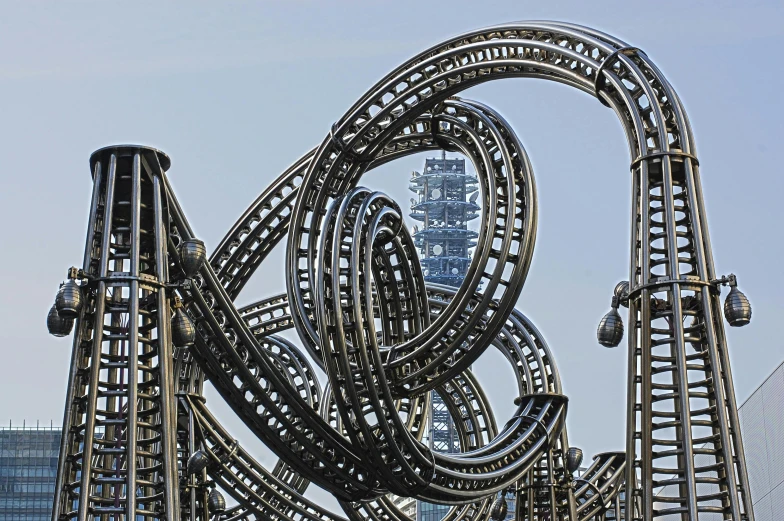 a close up of a roller coaster at a theme park, an abstract sculpture, inspired by Peter Gric, pexels contest winner, kinetic art, metal towers and sewers, album cover, ornate giger background, photo from 2022