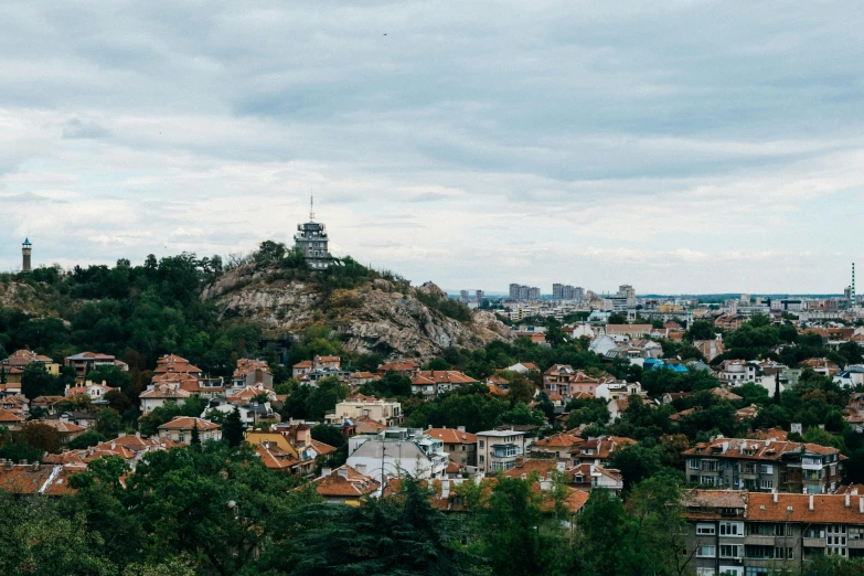 a view of a city from the top of a hill, by Emma Andijewska, unsplash contest winner, pagoda, orthodox, three - quarter view, square