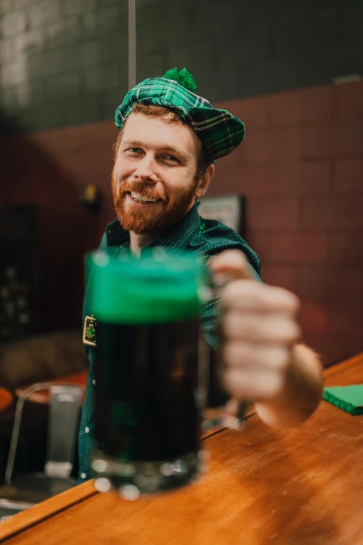 a man holding a glass of green beer, pexels contest winner, aussie baristas, hr ginger, avatar image, octoberfest