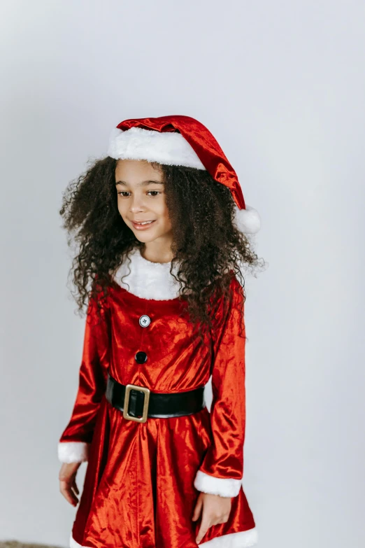 a little girl dressed up as santa claus, an album cover, pexels, incoherents, diverse costumes, curls, high resolution product photo, teen elf girl