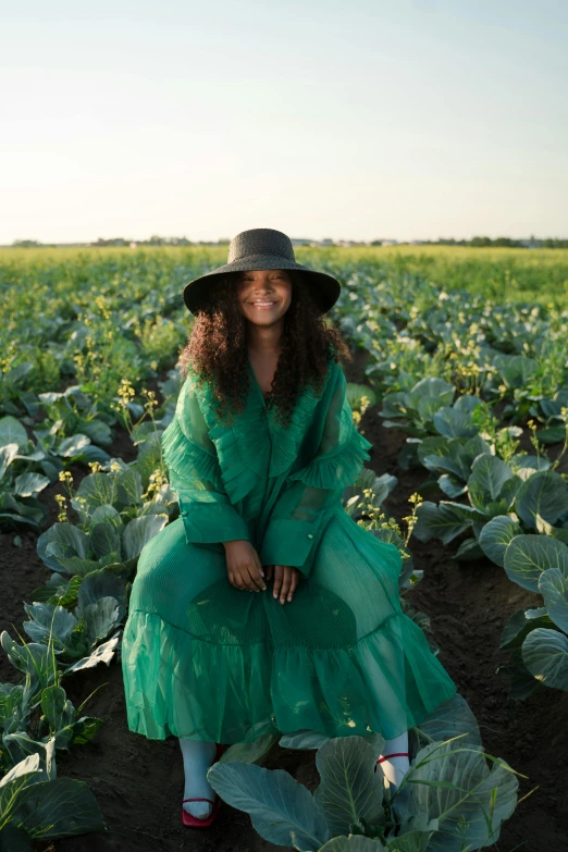 a woman sitting in a field of cabbage, pexels contest winner, renaissance, african american woman, wearing green clothing, sundown, tessa thompson inspired