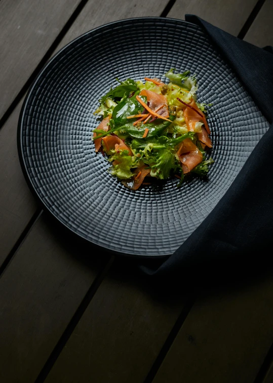 a close up of a plate of food on a table, slate, profile image, lettuce, product shot