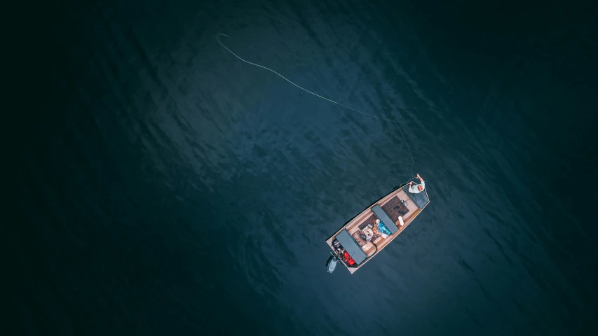a small boat floating on top of a large body of water, by Sebastian Spreng, pexels contest winner, people angling at the edge, topdown, deep colour, thumbnail