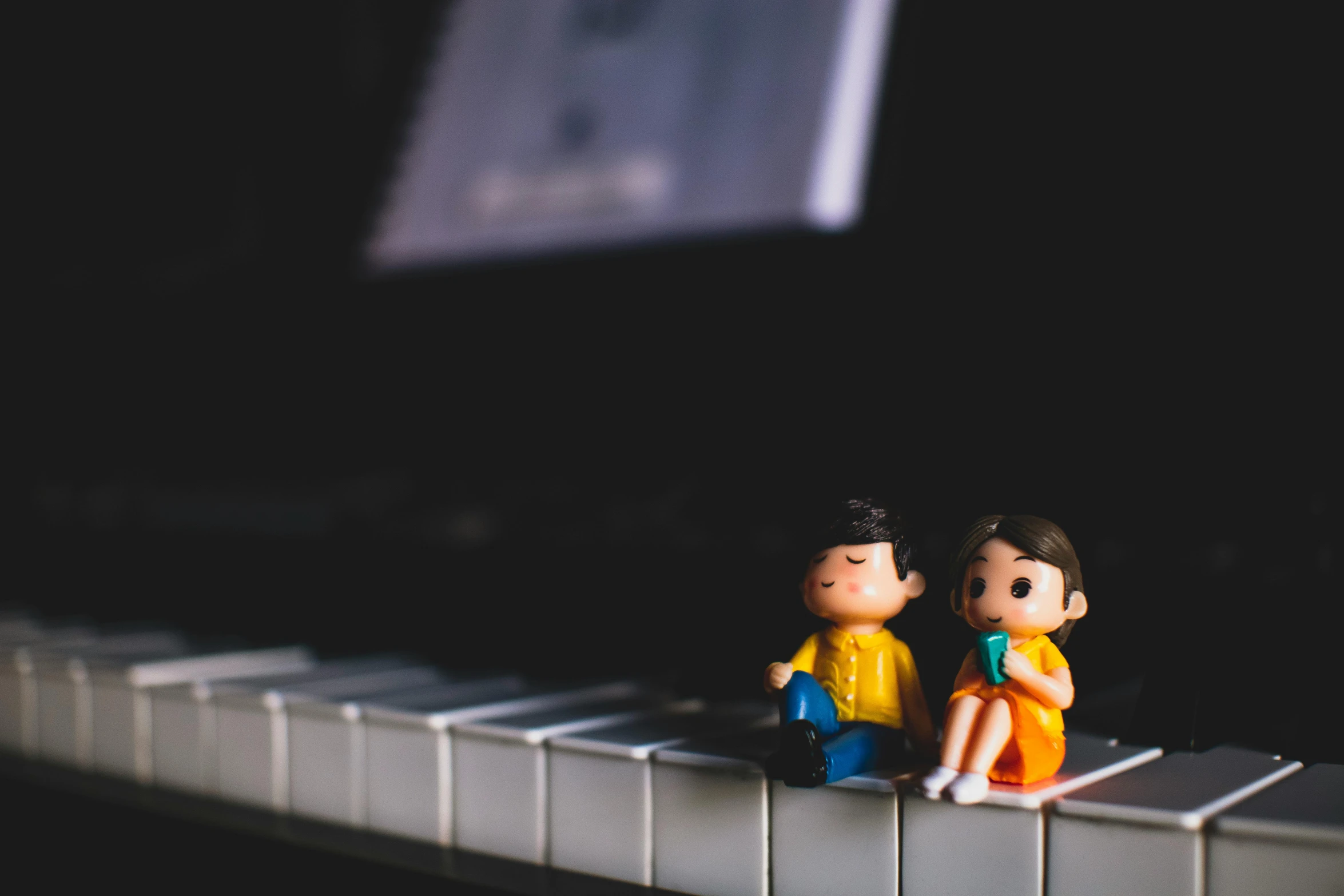 a couple of figurines sitting on top of a piano, pexels contest winner, children's toy, avatar image, instagram picture, toy photo