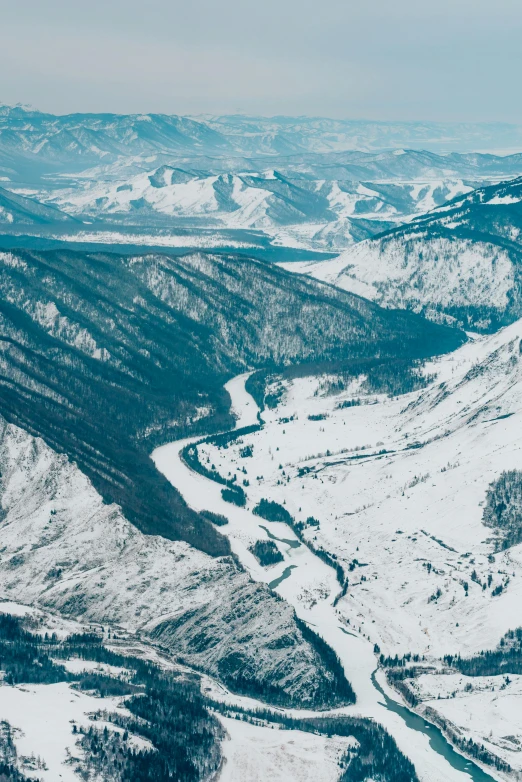 a snow covered mountain with a river running through it, ariel view, navy, feature, white