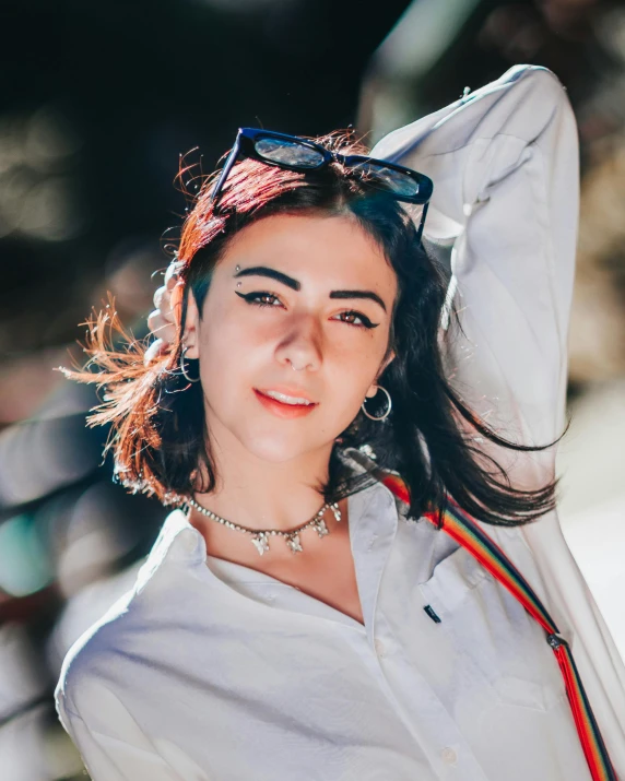 a woman in a white shirt is posing for a picture, inspired by Ion Andreescu, trending on pexels, hurufiyya, wearing choker, queer woman, middle eastern skin, wearing casual clothing