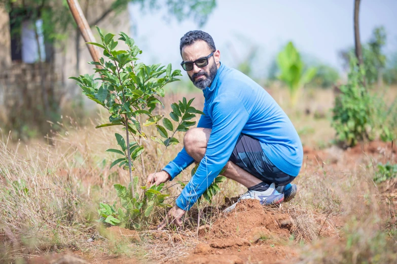 a man kneeling down to plant a tree, avatar image, wwf, a portrait of rahul kohli, 15081959 21121991 01012000 4k