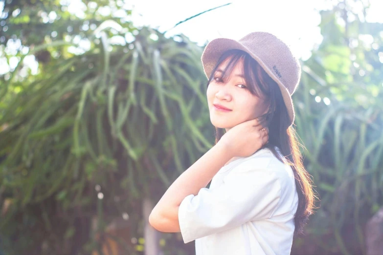 a woman in a hat poses for a picture, by Sengai, unsplash, visual art, soft backlighting, portrait image, anime thai girl, white