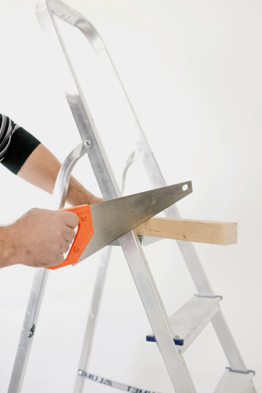 a man cutting a piece of wood with a pair of scissors, ladder, profile image, no - text no - logo, clean image