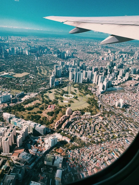 a view of a city from an airplane window, by Adam Rex, pexels contest winner, manila, parks and monuments, instagram story, detailed photo of virtual world