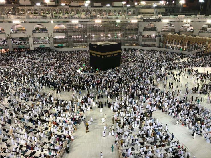 a large crowd of people standing around a building, a picture, by Meredith Dillman, pexels, hurufiyya, mecca, cavernous interior wide shot, 2 5 6 x 2 5 6 pixels, afp