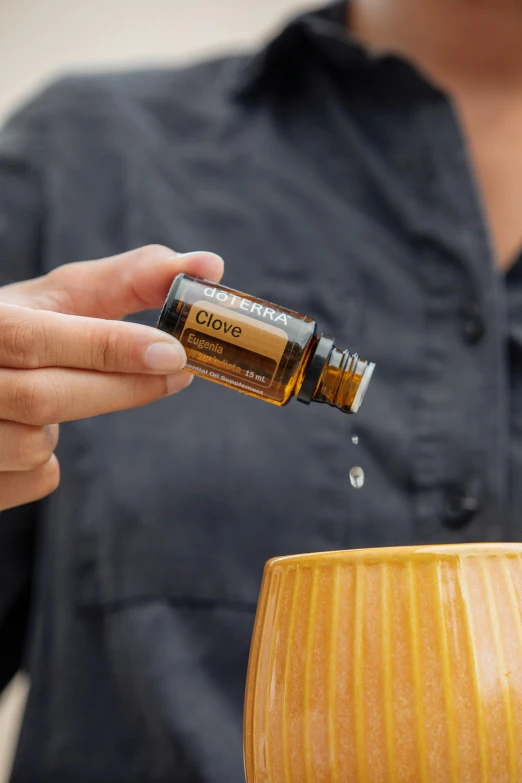 a close up of a person holding a bottle of essential oil, sienna, ultra detail, glue dropping, displayed