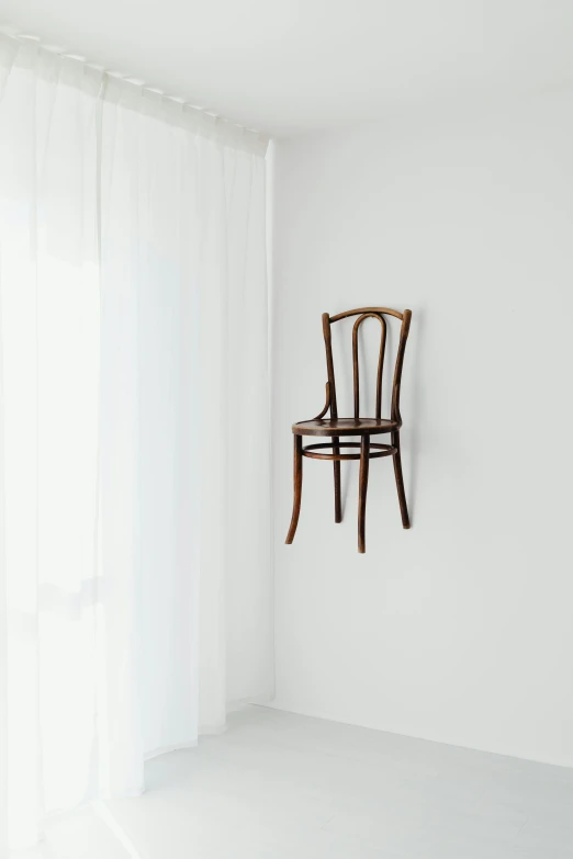 a wooden chair sitting on top of a white floor, inspired by Méret Oppenheim, unsplash, 2 5 6 x 2 5 6, weird art on the wall, hanging veins, conceptual installation