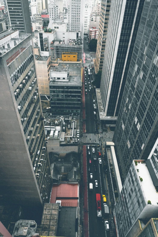 a city street filled with lots of tall buildings, inspired by Thomas Struth, pexels contest winner, top view of convertible, roofs, snapchat photo, skybridges