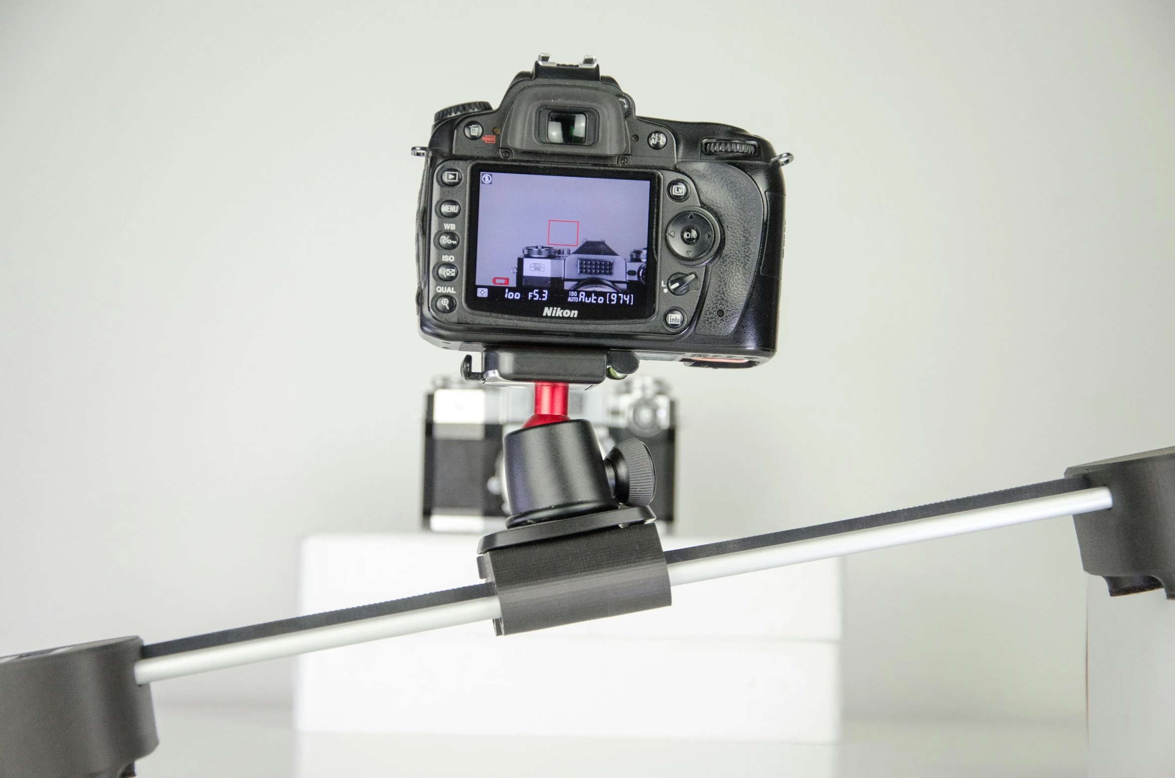 a close up of a camera on a tripod, a portrait, video art, full product shot, shot with hasselblade camera, medium wide front shot, perpendicular to the camera